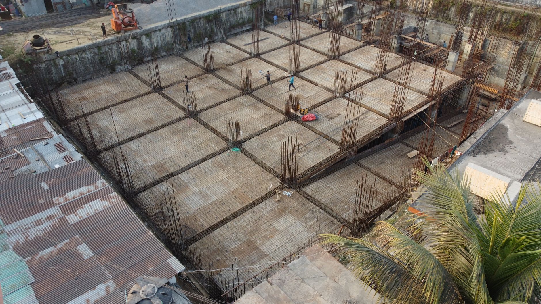 Overhead shot of construction workers at a large building site in Sylhet, Bangladesh.